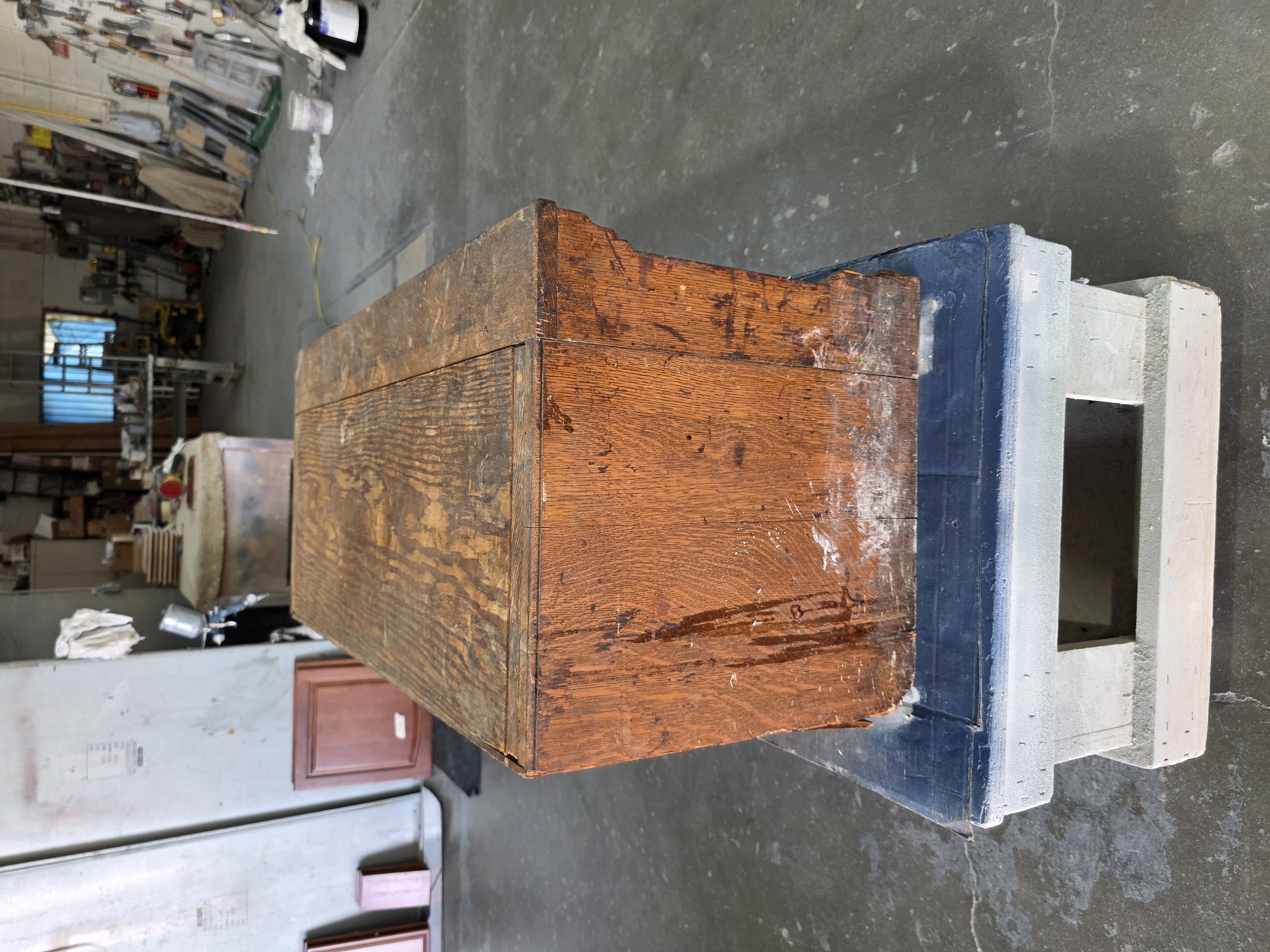 Side view of antique furniture piece in refinishing shop